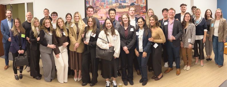 Wide image of dental students and professionals in business attire