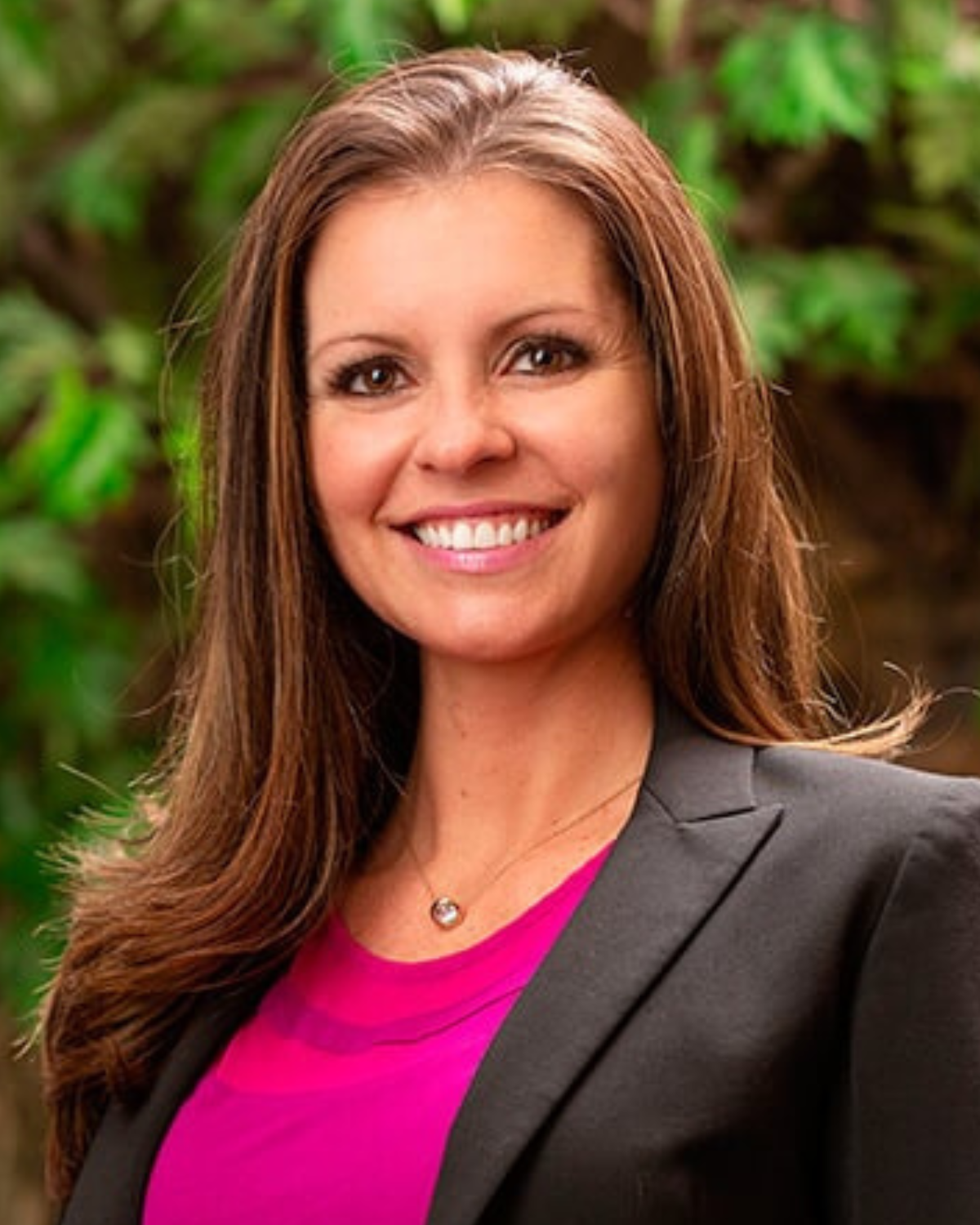 Dr. Mariah Frazier pictured with a hot pink blouse and black blazer