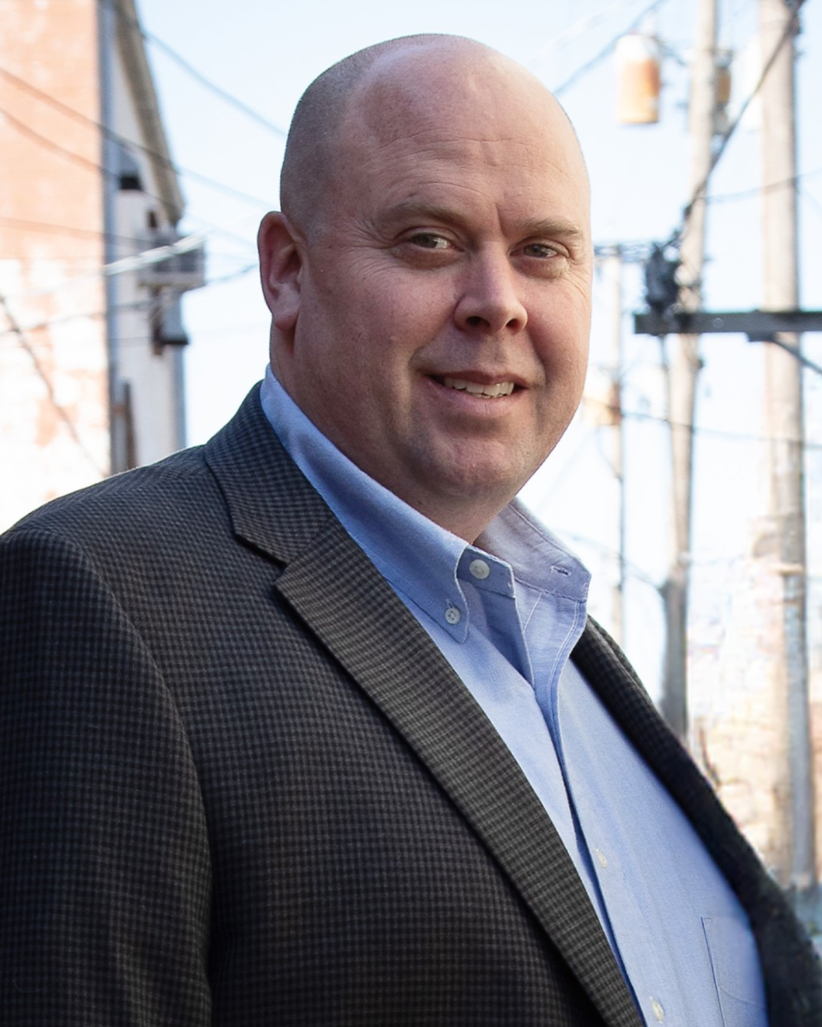 Dr. Nathan Niles pictured with a blue shirt and gray plaid blazer